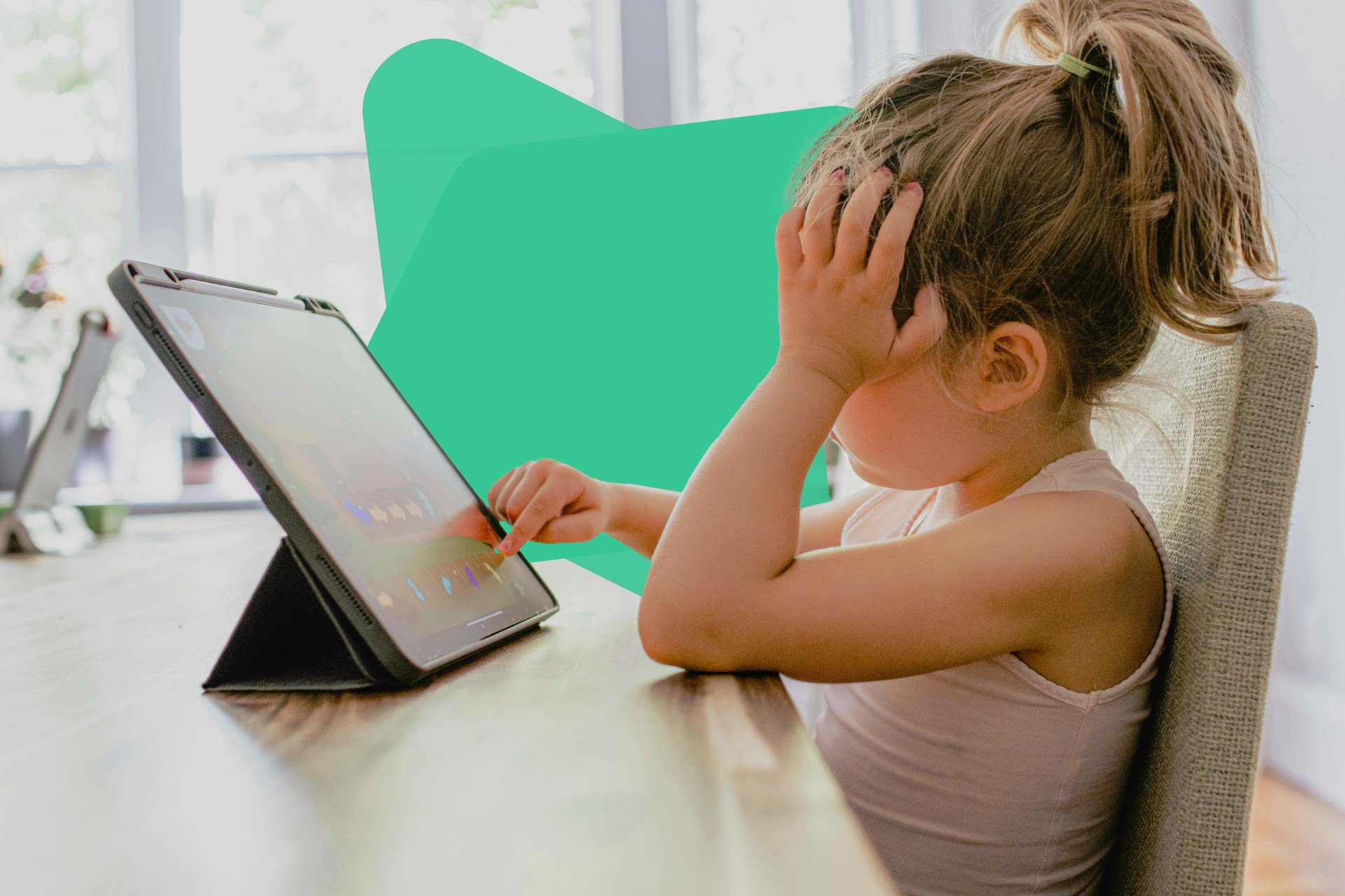 Enfant devant une tablette durant les vacances scolaires, illustrant les enjeux de sécurité en ligne